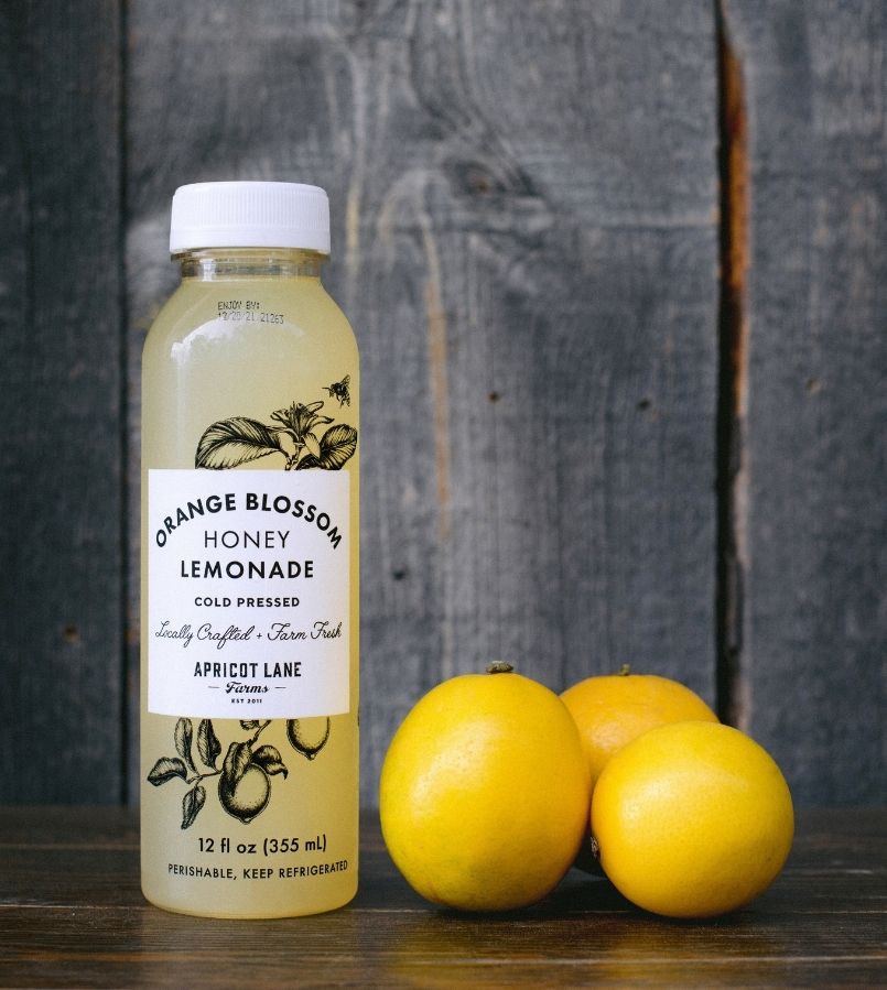 apricot lane farms lemonade bottle with stack of lemons