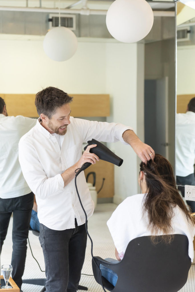 Jay Small of Arey blow drying hair